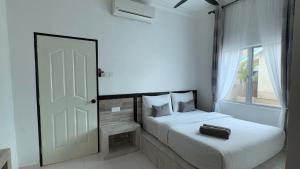 Postel nebo postele na pokoji v ubytování DVilla Guesthouse Langkawi