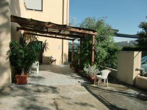a patio with two chairs and a pergola at Casa Martina in Pescara