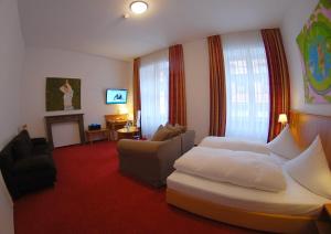 a hotel room with a bed and a couch at Hotel Mohren Post in Wangen im Allgäu