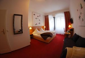 een hotelkamer met een bed en een spiegel bij Hotel Mohren Post in Wangen im Allgäu