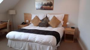 a bedroom with a large bed with pillows on it at Springfields in Horsham