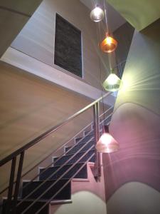 a staircase with three lights hanging from the ceiling at OktoHome Suite in Budapest