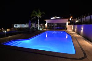 - une piscine avec une maison la nuit dans l'établissement Country Comfort Amity Motel, à Albany