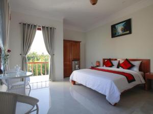 Voodi või voodid majutusasutuse Coconut Garden Homestay toas +33 fotot