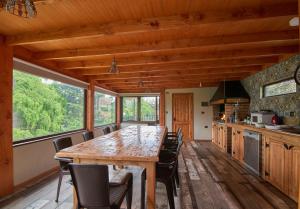 a kitchen with a large wooden table and chairs at mirabosque aparment ejecutivo 5 in Osorno