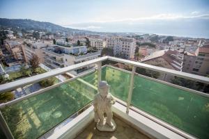 a statue on a balcony with a view of a city at Central Park Apartments by Connexion in Cannes