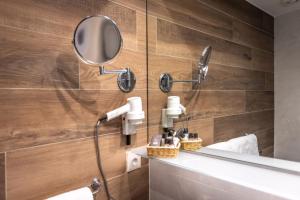 a bathroom with a shower and a mirror at Hotel Villa Margherita in Limone sul Garda +37 photos