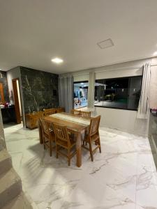 a dining room with a table and chairs at Casa de praia in Angra dos Reis