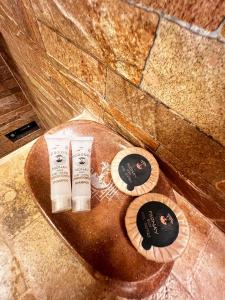 two products sitting on top of a toilet in a bathroom at PisonayMapiHotelBoutique in Machu Picchu +92 photos
