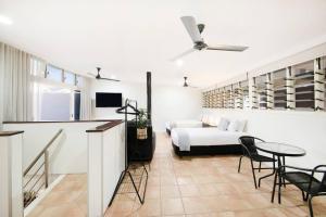 a room with a bed and a table and chairs at Sunset Penthouse - Unique Panoramic Rooftop Retreat in Larrakeyah +40 photos