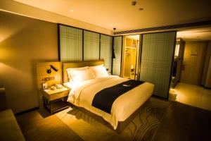 Ένα ή περισσότερα κρεβάτια σε δωμάτιο στο Echarm Hotel - Jingmen Yintai City Jingchu Institute of Technology