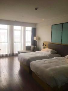 Ένα ή περισσότερα κρεβάτια σε δωμάτιο στο Echarm Hotel - Jingmen Yintai City Jingchu Institute of Technology