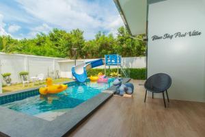a pool with a slide and a playground in a backyard at บลูสกาย พูลวิลล่า ชะอำ หัวหิน Blue Sky Pool Villa in Ban Bo Fai (1)