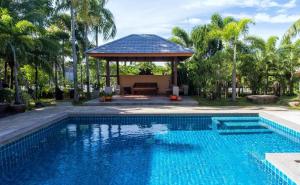 a swimming pool in front of a gazebo at Tamali Hotel in Ban Yuan Lae