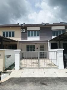 a house with a white gate in front of it at Kak Chik Homestay Tasek Gelugor in Kampong Ayer Melintas Besar