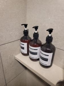 two bottles of soap sitting on a shelf in a bathroom at Hwagok August in Seoul