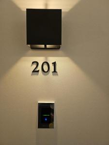 a sign on a wall with a television on it at Hwagok August in Seoul