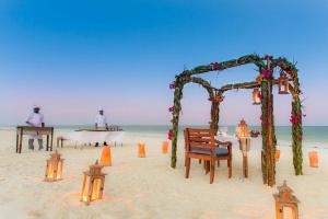 a wedding on the beach with an arch and lights at Kisiwa on the Beach in Paje