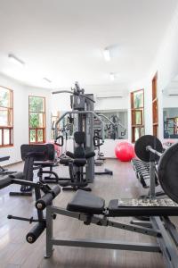 a gym with a lot of exercise equipment in a room at Kisiwa on the Beach in Paje