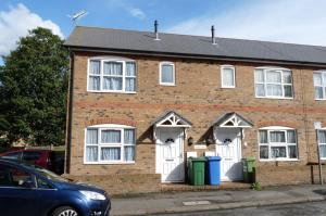 a brick house with white doors and windows at Friars Walk houses with 2 bedrooms, 2 bathrooms, fast Wi-Fi and private parking in Sittingbourne