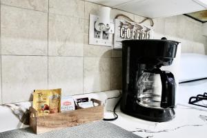 a coffee maker sitting on top of a kitchen counter at Private Room A-KING BED-12Mints NYCity Times Square in West New York