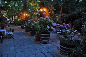a group of potted plants in barrels on a patio at Pelias Hotel in Portaria