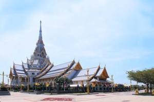 a large building with a tower on top of it at JK LIVING Hotel And Service Apartment in Chachoengsao
