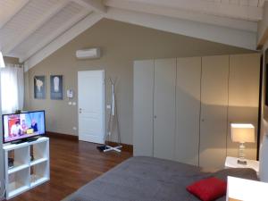 a living room with a bed and a tv at Residenza Porta D'Azeglio in Bologna