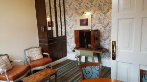 a living room with a tv and a table and chairs at The Hippodrome Wetherspoon in March