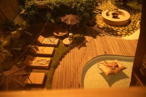 an overhead view of a woman laying on a table at Lulu's Wellness Boutique Villas in Uluwatu