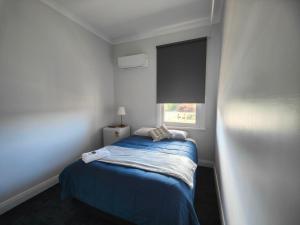 CollieにあるThe Club Hotel Collieのベッドと窓のある小さな寝室