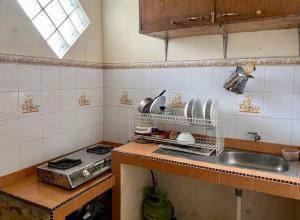 a kitchen with a sink and a counter top at Villa Sevilla 3 Bedrooms BPPK Ciloto Puncak by Damaresa in Tjiandjur +22 photos