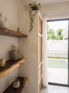 a room with wooden shelves and a window at Bali Escapes- Studio And 1 Bedroom Villa in Uluwatu +31 photos