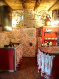 a kitchen with a stove and a counter top at Vistalago Guesthouse in Nemi