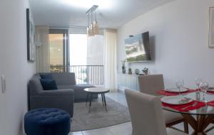 a living room with a table and a dining room at Condo 9, San Francisco Tower in San Salvador