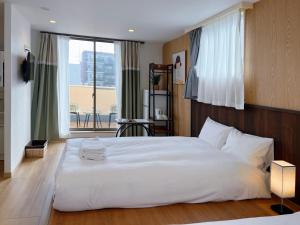 Postel nebo postele na pokoji v ubytování Softlight Inn Asakusa Tokyo + 37 fotografií