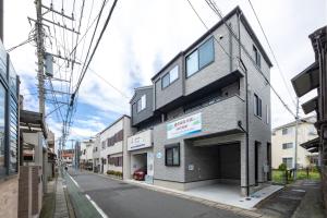 a gray building on the side of a street at 鎌倉由比ガ浜Home in Kamakura