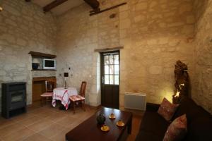 a living room with a couch and a table at Le Clos de la Garde in Anché