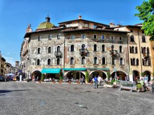 a large building with people walking in front of it at B&B al Palazzo Malfatti in Trento