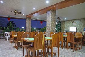 a dining room with wooden tables and chairs at R2R Bayview Inn in Coron