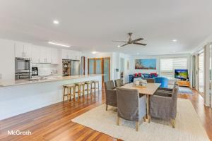 a kitchen and living room with a table and chairs at Sparkling Waters in Toormina