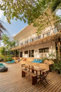 a wooden deck in front of a building at La Sana Surf Hotel, Playa Carmen in Santa Teresa Beach