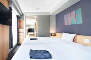 Postel nebo postele na pokoji v ubytování HOTEL Enmichi + 35 fotografií