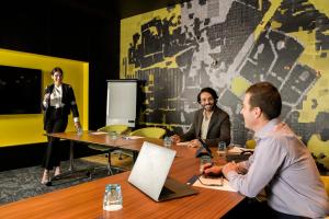 a group of people sitting around a table in a meeting room at Holiday Inn Express Newcastle by IHG in Newcastle