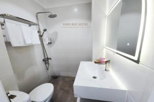 a white bathroom with a toilet and a sink at Khách sạn Kinh bắc in Ho Chi Minh City +12 photos