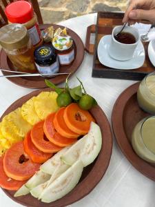 a table with two plates of food and a cup of coffee at THE LODGE by Eco Love in Galle