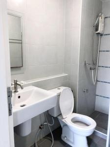 a bathroom with a white toilet and a sink at Dcondo campus resort Bangsaen in Ban Rong Khoei