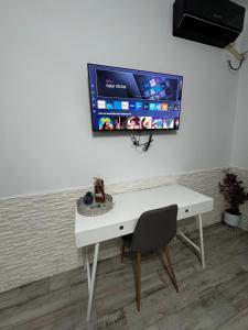 a white desk with a computer monitor on a wall at Apartament MaGiFa Mamaia Nord in Năvodari