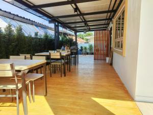 a restaurant with tables and chairs and a patio at Bewarm บีวอร์ม เชียงราย in Ban San Ton Ko (1)
