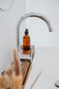 a soap dispenser sitting on a bathroom sink at The Oasis Villa in Ahangama